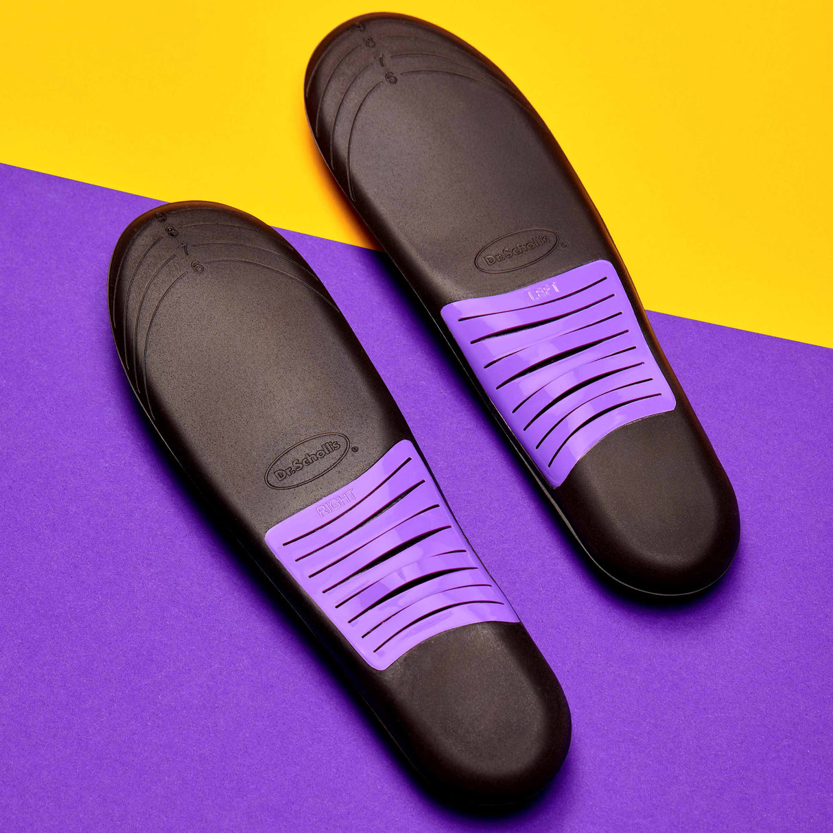 Pair of dark sneaker insoles with purple ventilation slots and cushioning top