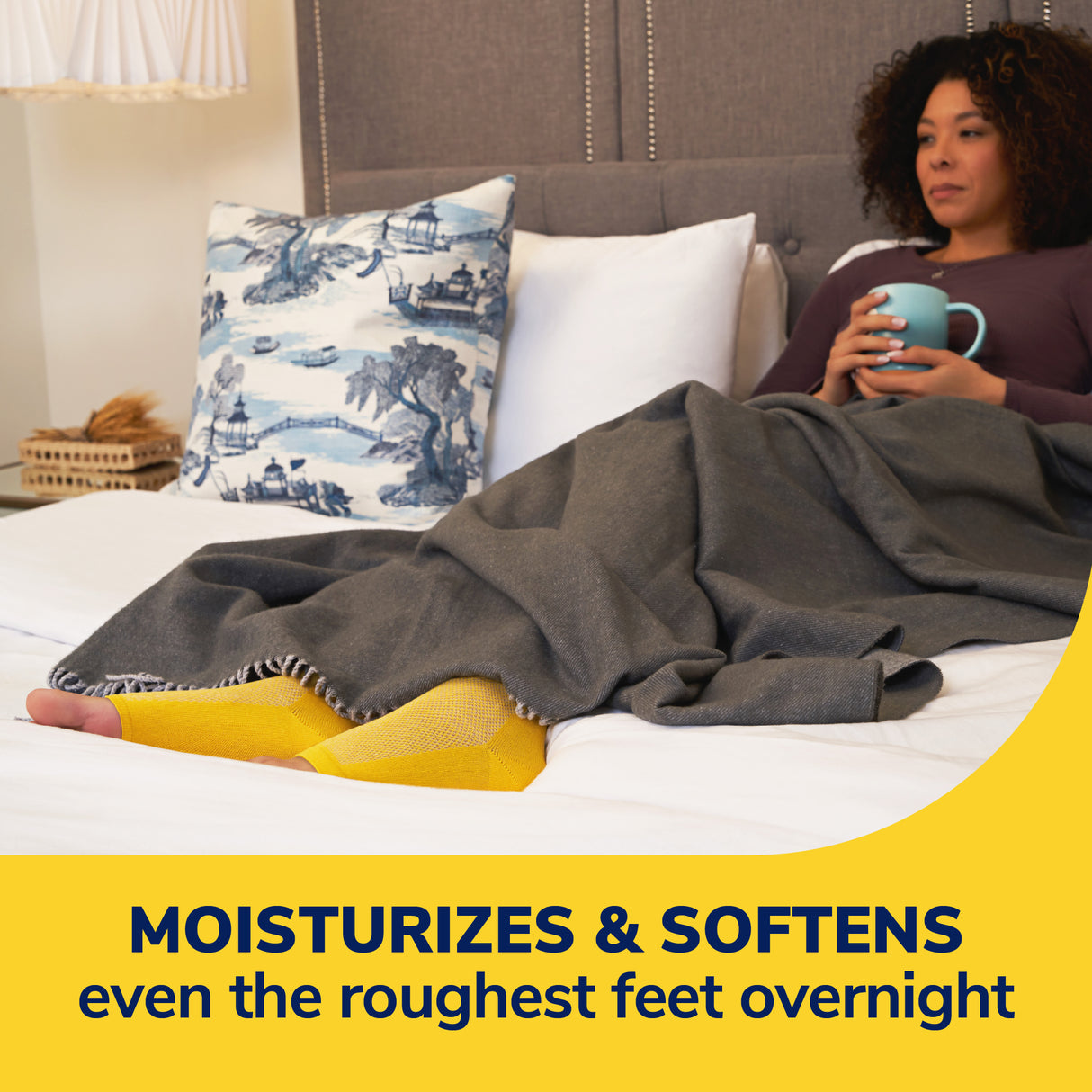 Person wearing yellow foot sleeves with Dr. Scholl's overnight foot treatment tube