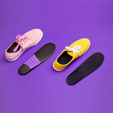 Set of sneaker insoles in black, pink, and yellow with cushioned top layer