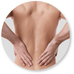 Image of person holding their lower back  due to lower back pain. 