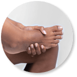 Image of person holding foot indicating  foot pain. 